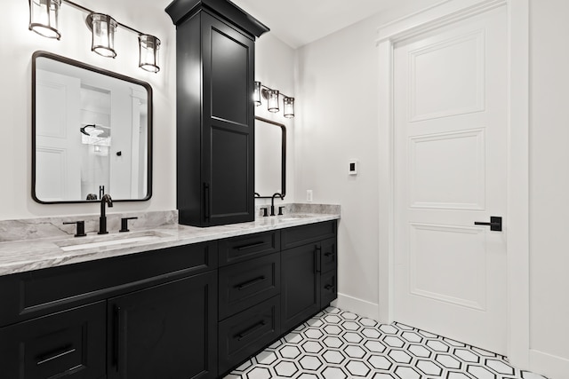 bathroom featuring double vanity, baseboards, and tile patterned floors