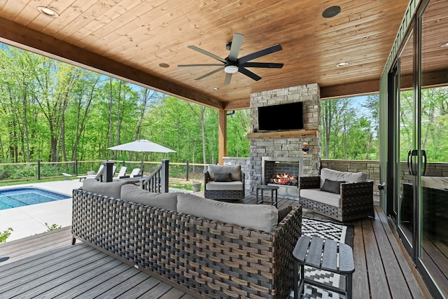 wooden terrace featuring an outdoor living space with a fireplace and ceiling fan