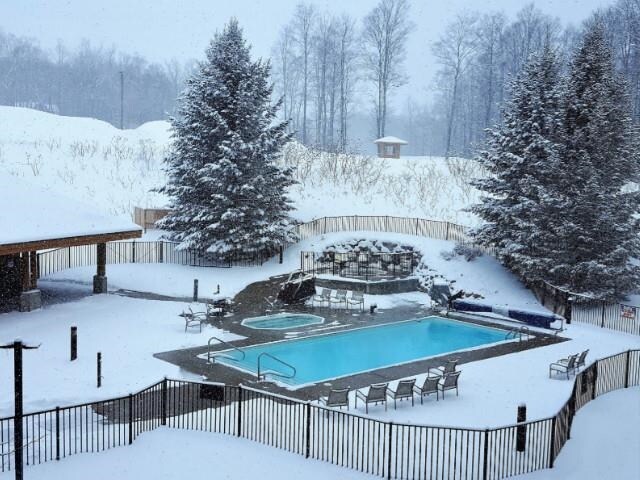2400 Troon S, Bellaire, MI 49615 - snow covered pool with a community hot tub, a community pool, and fence