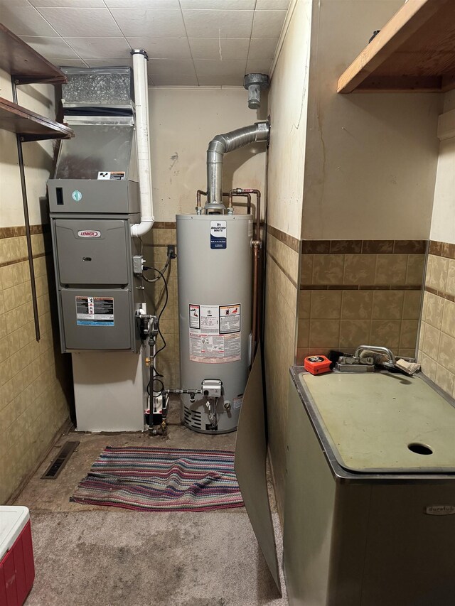 6126 Loud Dr, Oscoda, MI 48750 - utility room with water heater