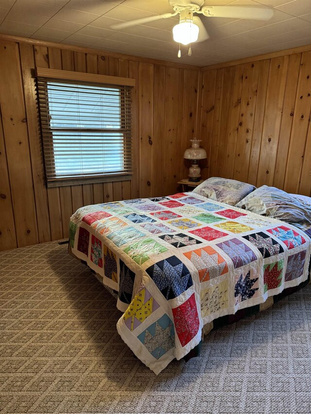6126 Loud Dr, Oscoda, MI 48750 - carpeted bedroom featuring wood walls
