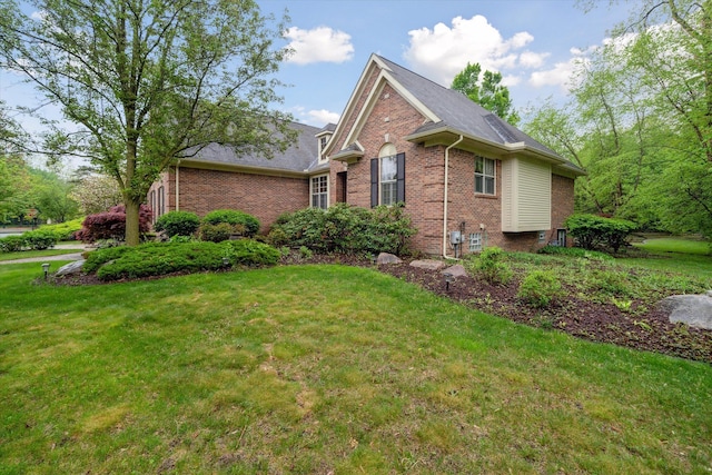 42259 White Hart Blvd, Canton, MI 48188 - view of front facade featuring brick siding, a front lawn, and a shingled roof