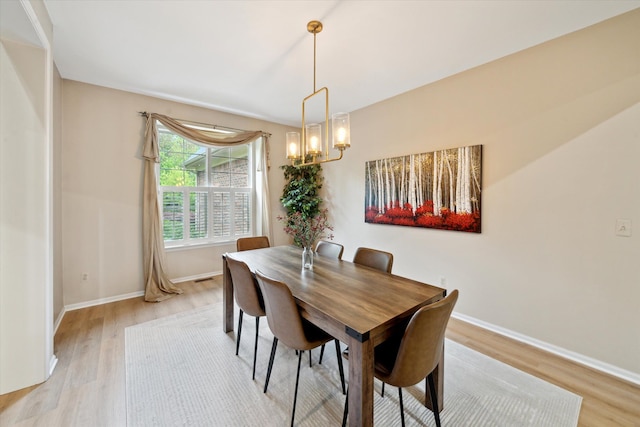 42259 White Hart Blvd, Canton, MI 48188 - dining space with light wood-style flooring, a chandelier, and baseboards