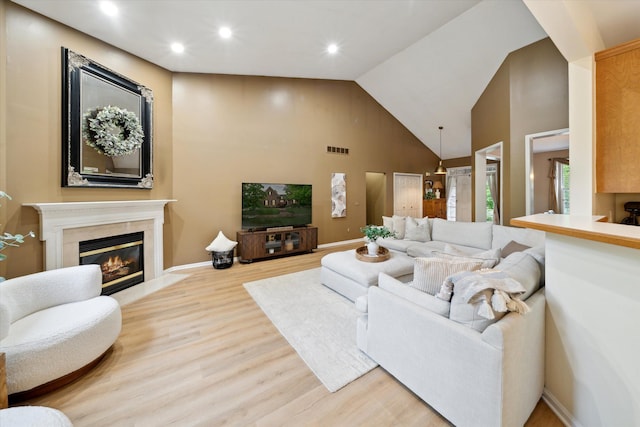 42259 White Hart Blvd, Canton, MI 48188 - living room with wood finished floors, a fireplace, high vaulted ceiling, recessed lighting, and baseboards
