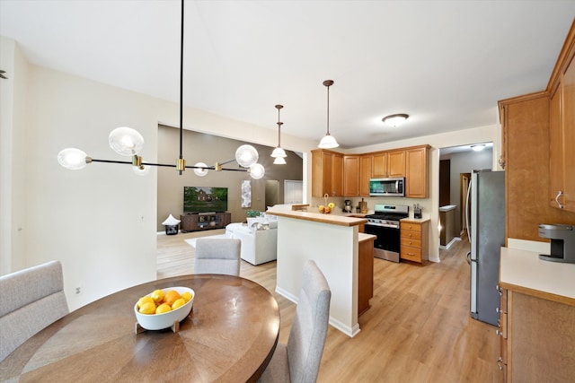 42259 White Hart Blvd, Canton, MI 48188 - kitchen with appliances with stainless steel finishes, open floor plan, light wood-style floors, and light countertops