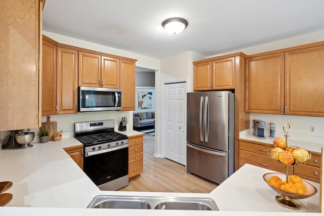 42259 White Hart Blvd, Canton, MI 48188 - kitchen with appliances with stainless steel finishes, light countertops, light wood finished floors, and brown cabinetry