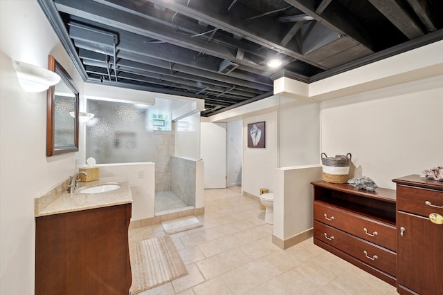 42259 White Hart Blvd, Canton, MI 48188 - bathroom featuring a tile shower, vanity, toilet, tile patterned flooring, and baseboards