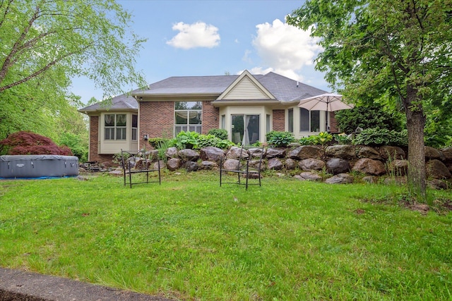 42259 White Hart Blvd, Canton, MI 48188 - back of house with brick siding and a yard