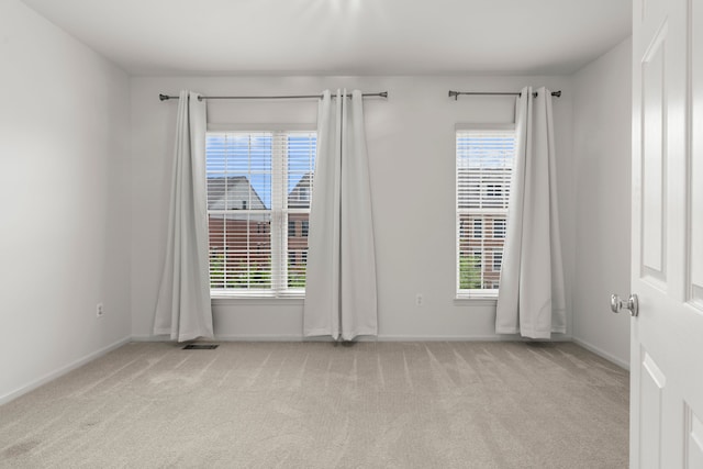 unfurnished room with carpet floors and baseboards