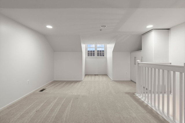 additional living space featuring recessed lighting, light colored carpet, and baseboards