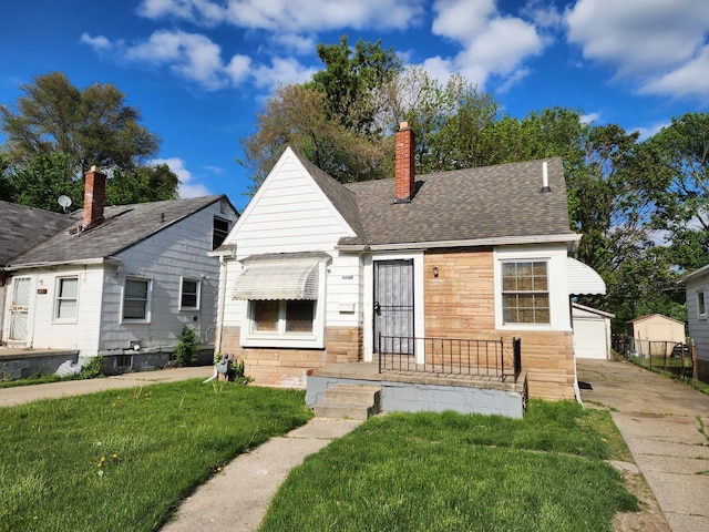 8428 Rosemont Ave, Detroit, MI 48228 - bungalow-style house featuring a front yard, a chimney, a garage, an outbuilding, and a shingled roof