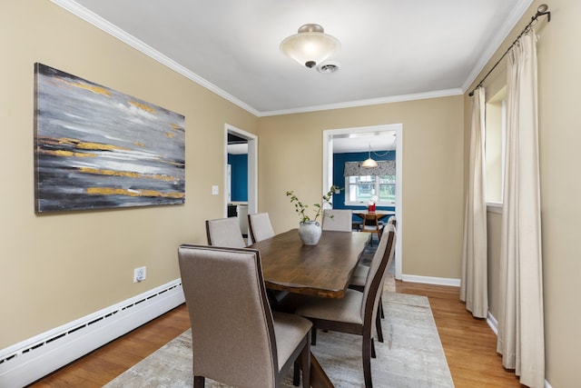 212 W Mckay St, Saline, MI 48176 - dining space with a baseboard heating unit, crown molding, light wood-type flooring, and baseboards