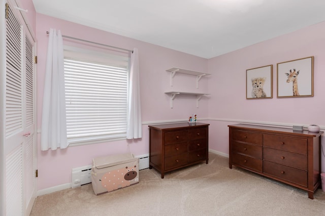 212 W Mckay St, Saline, MI 48176 - bedroom featuring light colored carpet, a closet, baseboards, and a baseboard heating unit