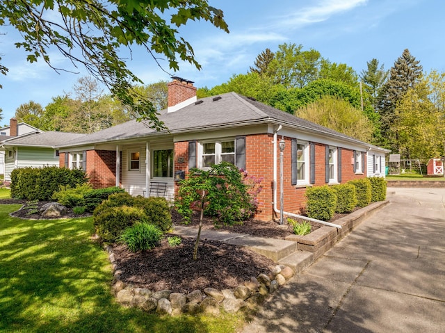 212 W Mckay St, Saline, MI 48176 - view of side of home featuring brick siding, a chimney, a lawn, and a shingled roof
