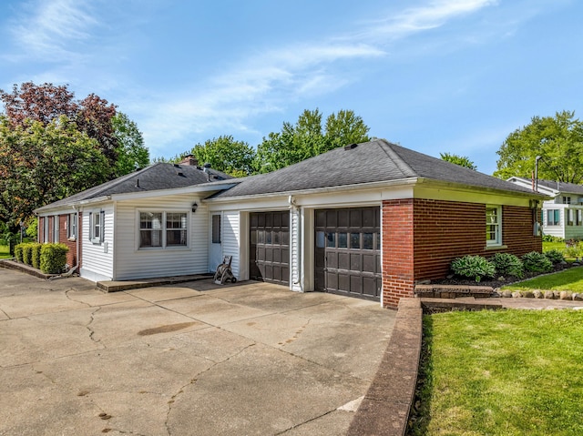 212 W Mckay St, Saline, MI 48176 - view of front of house featuring a garage, concrete driveway, brick siding, and roof with shingles