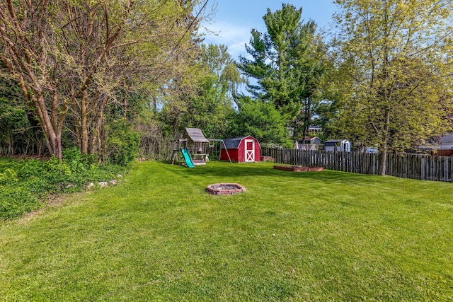 212 W Mckay St, Saline, MI 48176 - view of yard with a storage shed, a playground, an outbuilding, and an outdoor fire pit