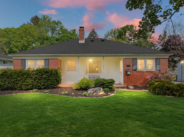 212 W Mckay St, Saline, MI 48176 - view of front of house with brick siding, a chimney, a lawn, and a porch