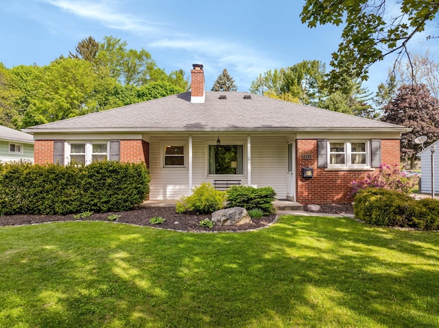 212 W Mckay St, Saline, MI 48176 - view of front of house with brick siding, a chimney, a front yard, and a porch