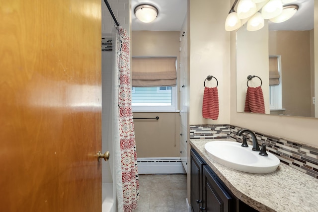 212 W Mckay St, Saline, MI 48176 - bathroom with a baseboard heating unit, decorative backsplash, vanity, and tile patterned flooring