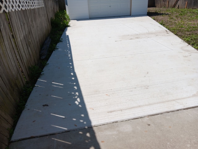 2209 Progress Ave, Lincoln Park, MI 48146 - view of patio / terrace with a garage, concrete driveway, and fence