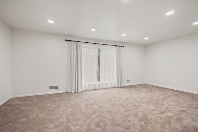 carpeted spare room featuring recessed lighting and baseboards