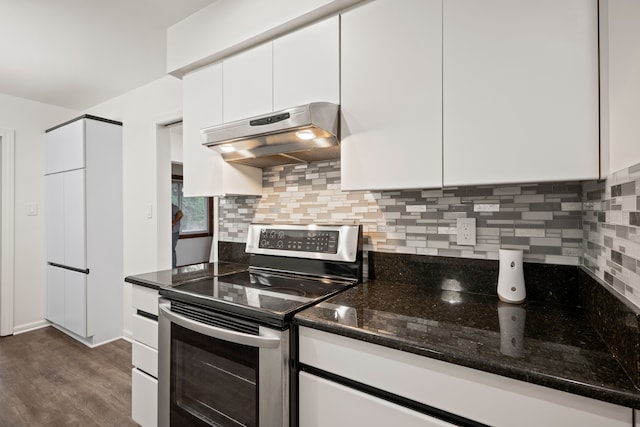 kitchen with stainless steel electric range, under cabinet range hood, white cabinets, tasteful backsplash, and dark wood finished floors