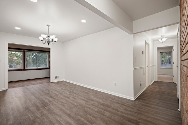 unfurnished room with a chandelier, dark wood finished floors, baseboards, and recessed lighting