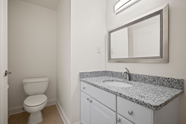 bathroom featuring baseboards, toilet, tile patterned floors, and vanity