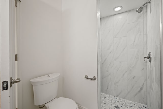 bathroom with a stall shower and toilet