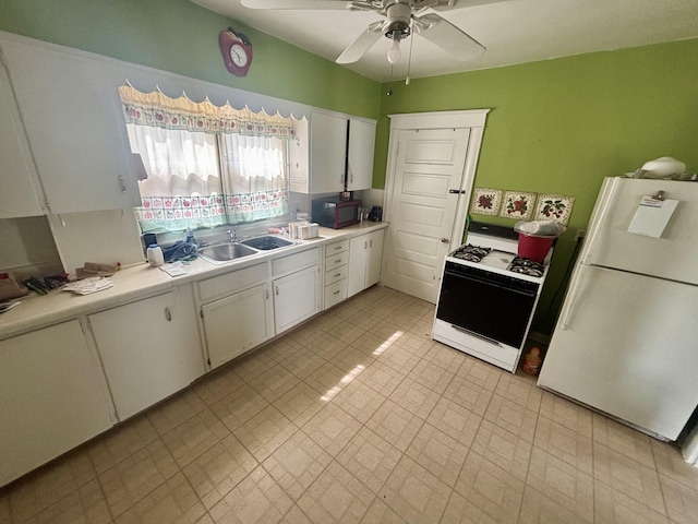 kitchen with white appliances, a sink, light countertops, ceiling fan, and white cabinets