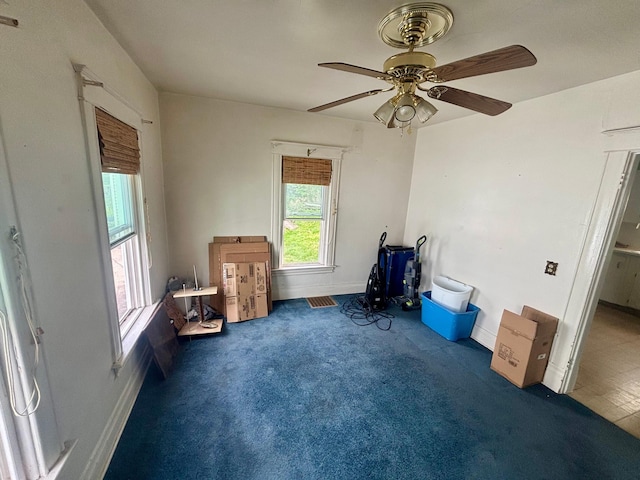 miscellaneous room featuring carpet floors, baseboards, and a ceiling fan