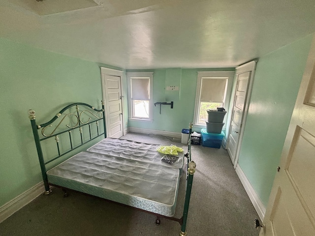 bedroom with baseboards and carpet