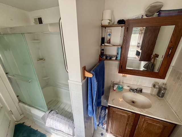 full bathroom featuring tasteful backsplash and vanity
