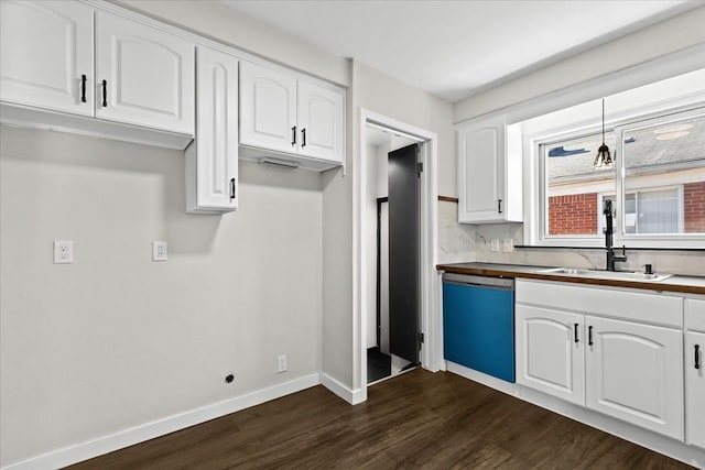 kitchen featuring dishwasher, a sink, dark wood-type flooring, and white cabinetry