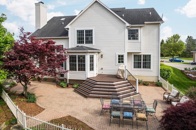 1433 Bicentennial Pkwy, Ann Arbor, MI 48108 - back of property with a fenced backyard, a patio area, a chimney, a shingled roof, and a deck