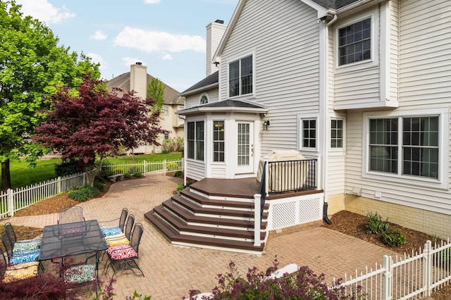 1433 Bicentennial Pkwy, Ann Arbor, MI 48108 - back of house with a wooden deck, a patio area, a fenced backyard, a chimney, and a shingled roof
