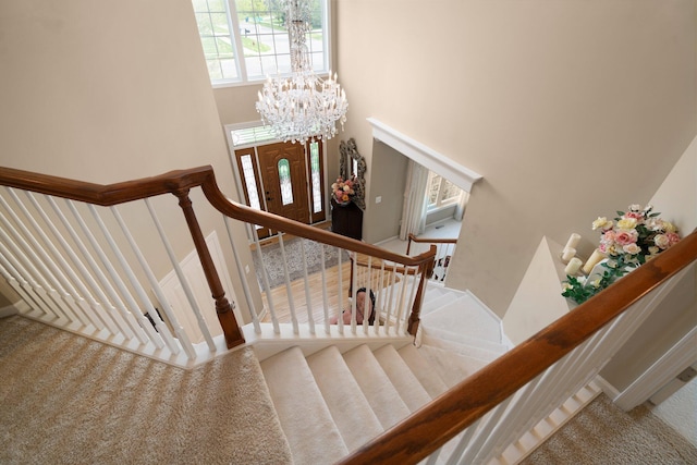 1433 Bicentennial Pkwy, Ann Arbor, MI 48108 - stairway with carpet flooring, a chandelier, and a towering ceiling