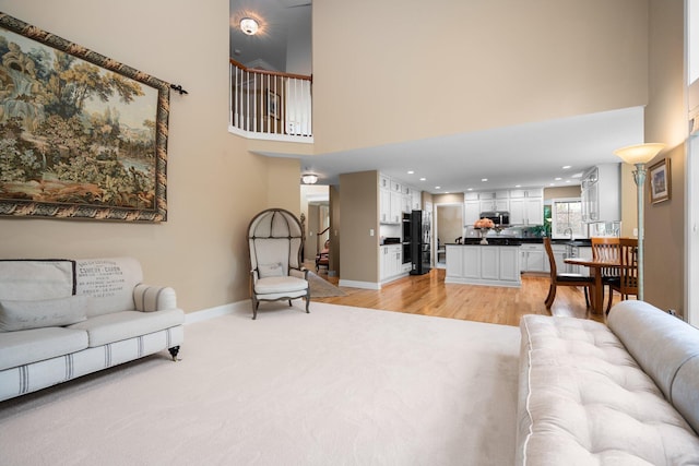 1433 Bicentennial Pkwy, Ann Arbor, MI 48108 - living area featuring a high ceiling, light wood-type flooring, baseboards, and recessed lighting