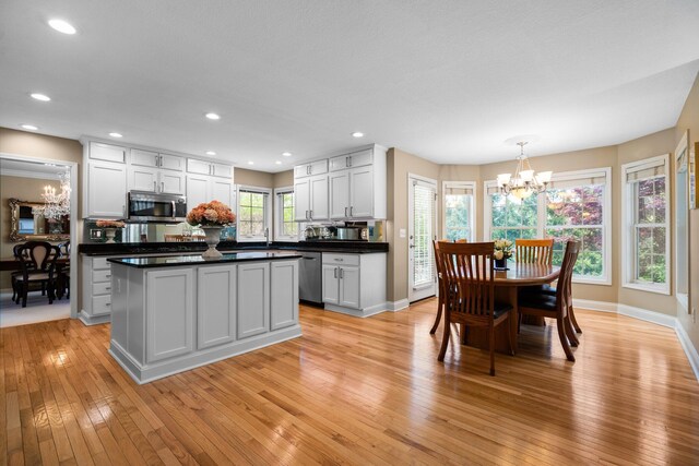 1433 Bicentennial Pkwy, Ann Arbor, MI 48108 - kitchen featuring a chandelier, stainless steel appliances, dark countertops, light wood-type flooring, and recessed lighting