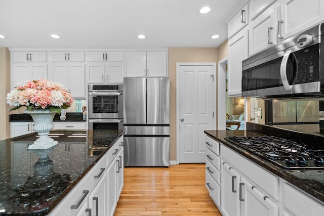 1433 Bicentennial Pkwy, Ann Arbor, MI 48108 - kitchen with stainless steel appliances, white cabinetry, light wood finished floors, recessed lighting, and dark stone countertops