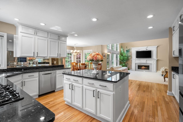 1433 Bicentennial Pkwy, Ann Arbor, MI 48108 - kitchen featuring dishwasher, a lit fireplace, white cabinetry, light wood-type flooring, and recessed lighting