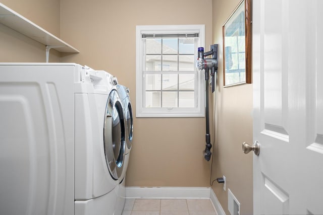 1433 Bicentennial Pkwy, Ann Arbor, MI 48108 - clothes washing area featuring washing machine and dryer, baseboards, and tile patterned floors