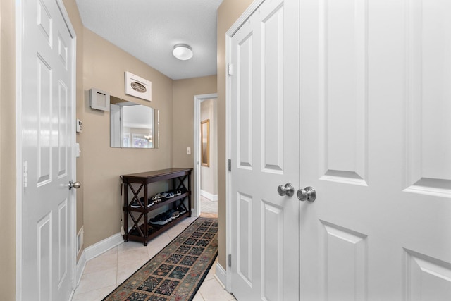 1433 Bicentennial Pkwy, Ann Arbor, MI 48108 - doorway featuring baseboards and light tile patterned floors