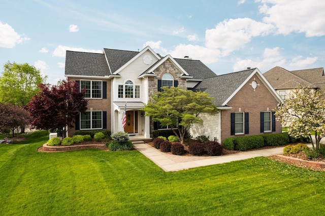 1433 Bicentennial Pkwy, Ann Arbor, MI 48108 - view of front facade with a front yard, brick siding, and roof with shingles