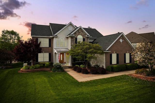 1433 Bicentennial Pkwy, Ann Arbor, MI 48108 - view of front of home featuring a yard, brick siding, and roof with shingles