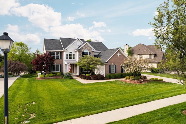 1433 Bicentennial Pkwy, Ann Arbor, MI 48108 - traditional-style home with a front lawn, brick siding, and a chimney