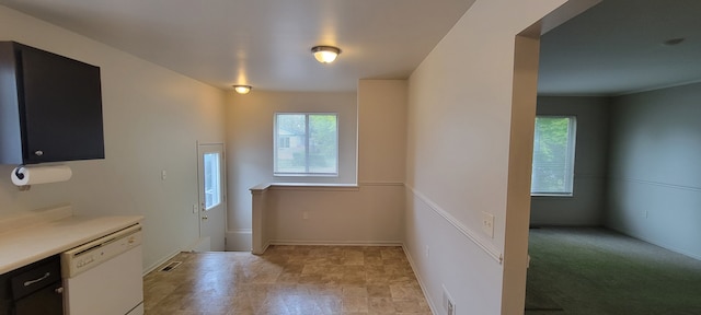 21276 Abrahm St, Clinton Township, MI 48035 - kitchen with white dishwasher, light countertops, baseboards, and dark cabinetry