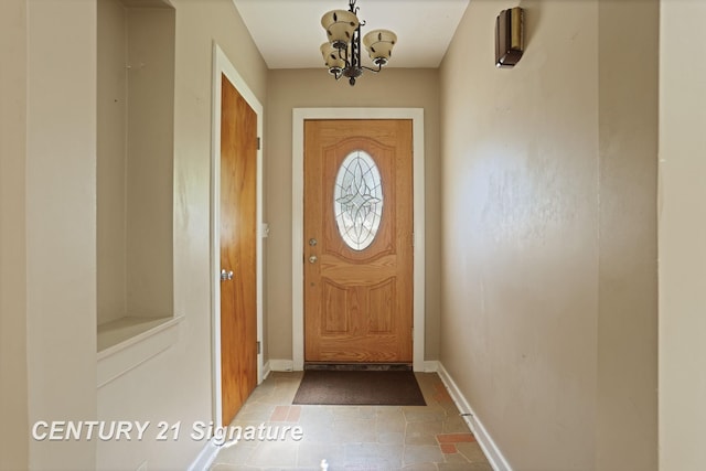 1415 Coolidge Ave, Saginaw, MI 48638 - entryway featuring baseboards and a chandelier