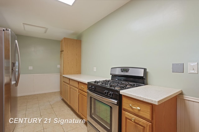 1415 Coolidge Ave, Saginaw, MI 48638 - kitchen with appliances with stainless steel finishes, wainscoting, light countertops, and light tile patterned flooring