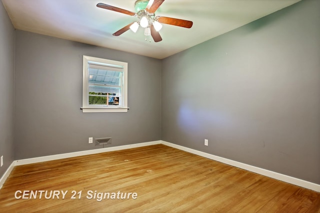 1415 Coolidge Ave, Saginaw, MI 48638 - unfurnished room with baseboards, wood finished floors, and a ceiling fan